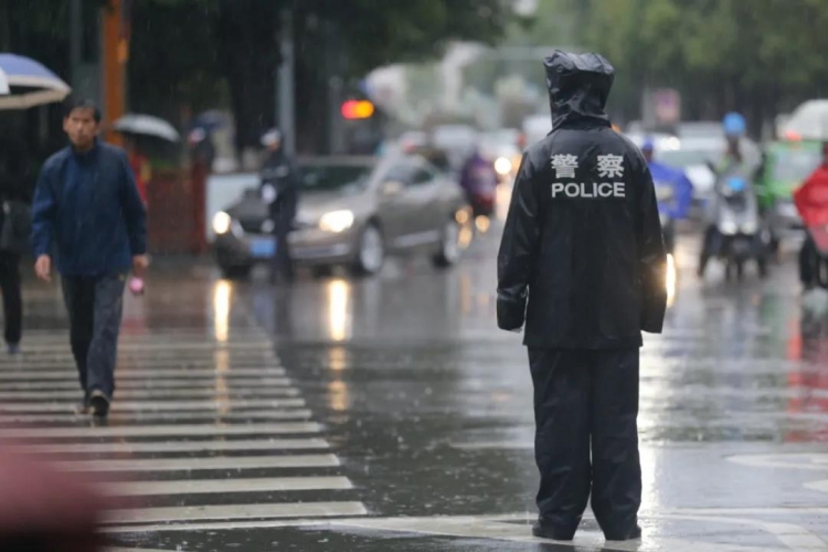 暖心！下雨天执勤人员全身湿透，路人小哥向执勤交警送出自己的伞 (1).jpg